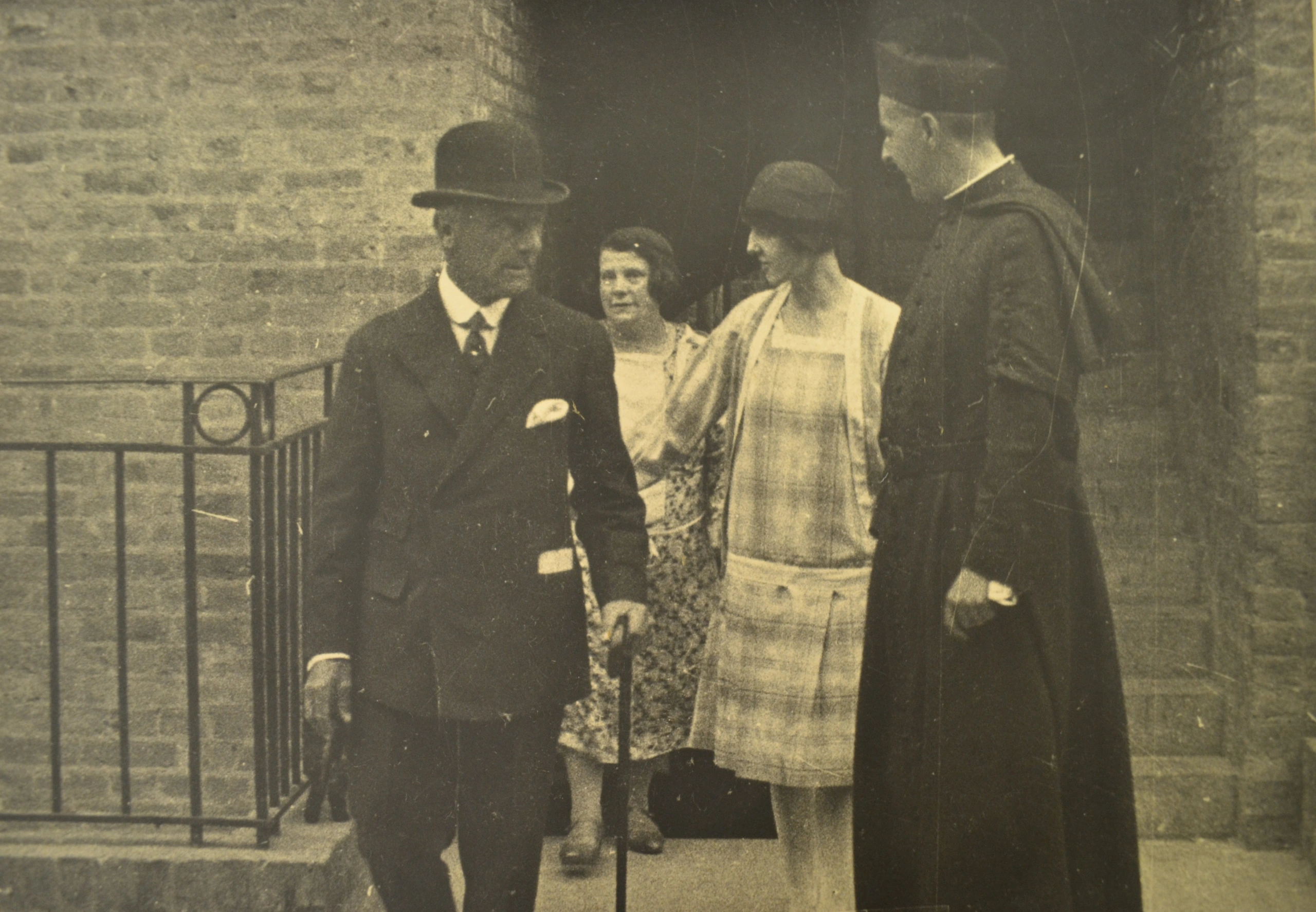 Lord Jellicoe, Father Jellicoe and Irene Barclay leaving the first block of St Mary's flats July 1928.